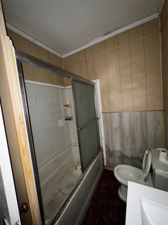 1205 W Arlington Ave, Fort Worth, TX 76110 - bathroom with crown molding, toilet, combined bath / shower with glass door, and a sink