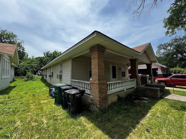 1205 W Arlington Ave, Fort Worth, TX 76110 - view of side of property featuring a porch and a yard