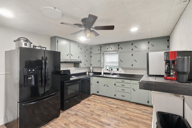 604 S Chestnut St, Winnsboro, TX 75494 - kitchen with black appliances, a sink, dark countertops, ceiling fan, and light wood-style flooring