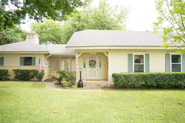 1218 Park Dr, Hillsboro, TX 76645 - view of front facade featuring a shingled roof, a front yard, and a chimney