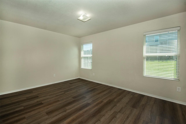 1407 Swan Ridge Dr, Sherman, TX 75092 - empty room featuring dark wood-style floors and baseboards