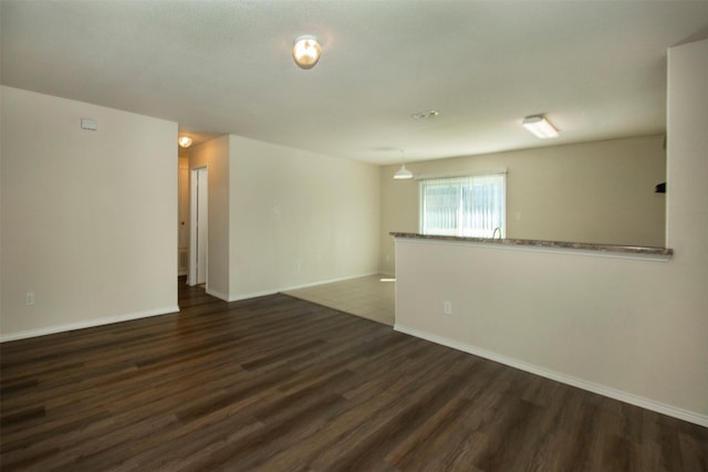 1407 Swan Ridge Dr, Sherman, TX 75092 - spare room featuring dark wood finished floors and baseboards