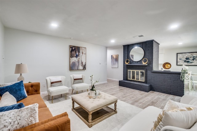 2209 Sheriff Dr, Grand Prairie, TX 75051 - living area featuring recessed lighting, baseboards, light wood-type flooring, and a brick fireplace
