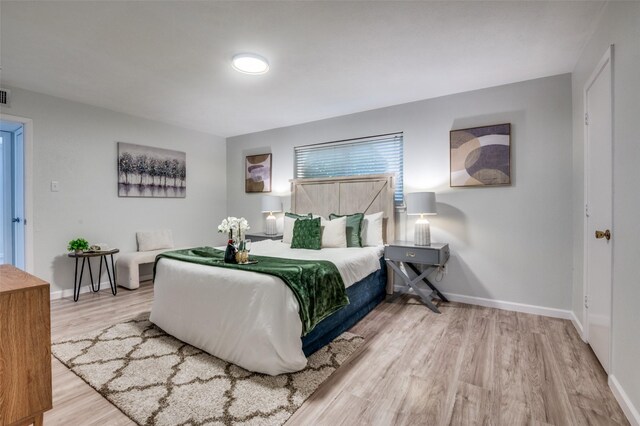 2209 Sheriff Dr, Grand Prairie, TX 75051 - bedroom featuring wood finished floors and baseboards