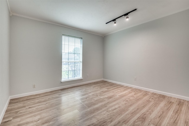 2209 Sheriff Dr, Grand Prairie, TX 75051 - unfurnished room with crown molding, light wood-style flooring, track lighting, and baseboards