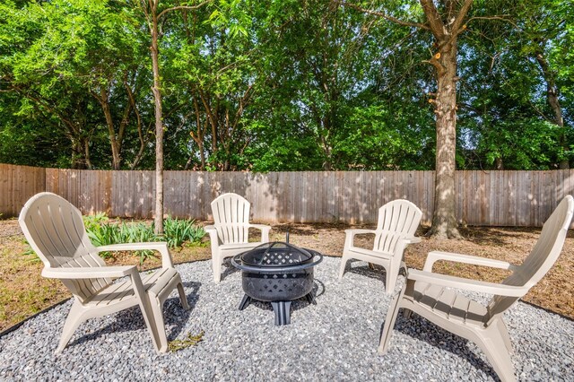 2209 Sheriff Dr, Grand Prairie, TX 75051 - view of patio with a fire pit and fence