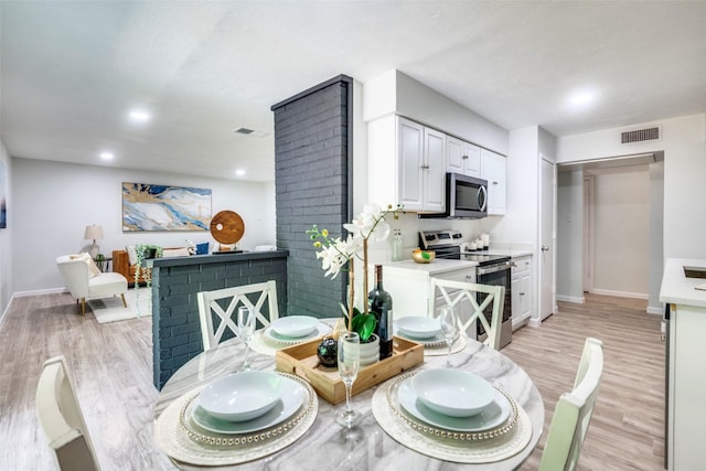 2209 Sheriff Dr, Grand Prairie, TX 75051 - dining area featuring light wood-style floors and recessed lighting