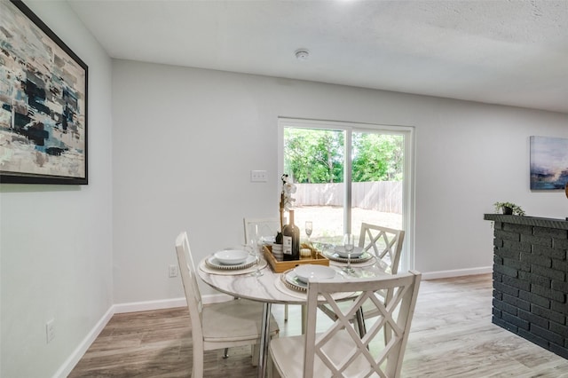2209 Sheriff Dr, Grand Prairie, TX 75051 - dining space featuring light wood-type flooring and baseboards