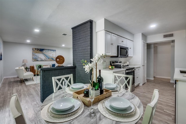 2209 Sheriff Dr, Grand Prairie, TX 75051 - dining area with light wood finished floors, recessed lighting, and baseboards
