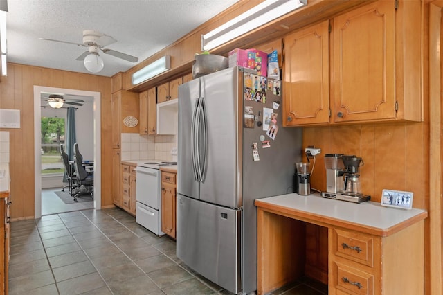 115 Mill Pond Rd, Denton, TX 76209 - kitchen with white electric stove, freestanding refrigerator, ceiling fan, an office area, and light countertops