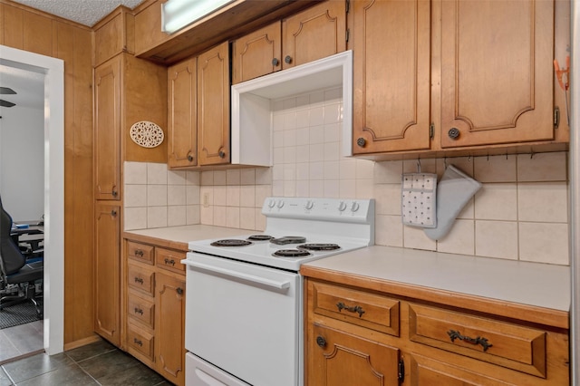 115 Mill Pond Rd, Denton, TX 76209 - kitchen featuring white range with electric cooktop, light countertops, and backsplash