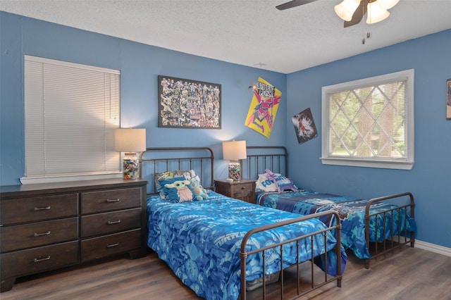 115 Mill Pond Rd, Denton, TX 76209 - bedroom with wood finished floors, a textured ceiling, baseboards, and ceiling fan