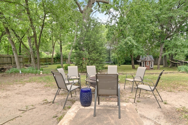 115 Mill Pond Rd, Denton, TX 76209 - view of patio with an outbuilding, fence, and view of scattered trees