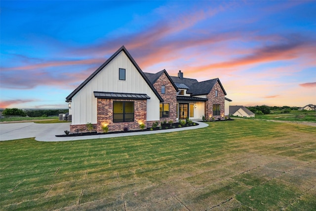 500 Longhorn Dr, Springtown, TX 76082 - modern farmhouse style home featuring a standing seam roof, board and batten siding, a lawn, and metal roof