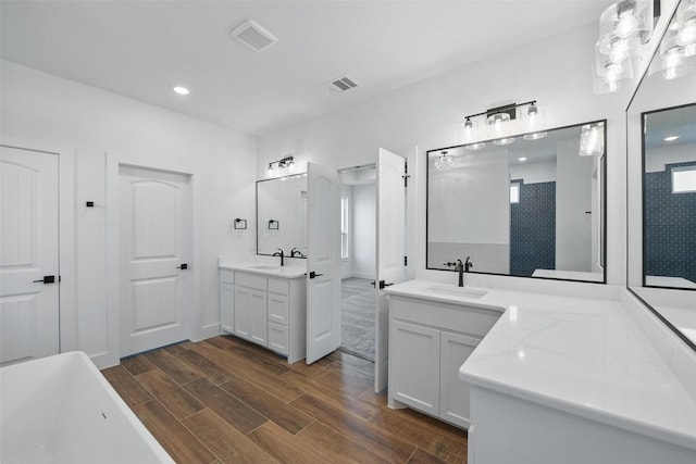 500 Longhorn Dr, Springtown, TX 76082 - bathroom with wood finished floors, two vanities, a freestanding bath, and recessed lighting