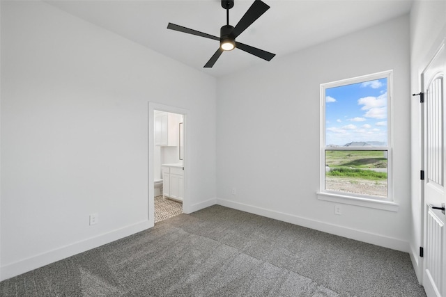 500 Longhorn Dr, Springtown, TX 76082 - unfurnished bedroom with carpet floors, baseboards, ensuite bath, and a ceiling fan