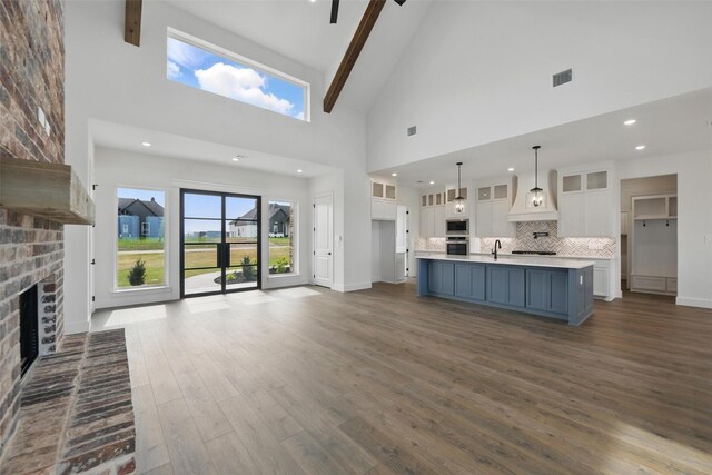 500 Longhorn Dr, Springtown, TX 76082 - unfurnished living room featuring high vaulted ceiling, dark wood-type flooring, a fireplace, baseboards, and recessed lighting