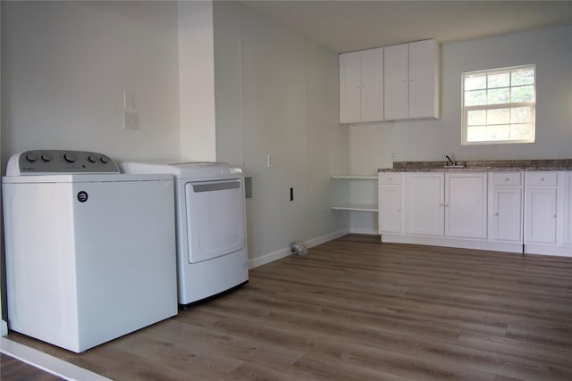 103 N 6th St E, Dawson, TX 76639 - laundry area featuring independent washer and dryer, cabinet space, wood finished floors, and baseboards
