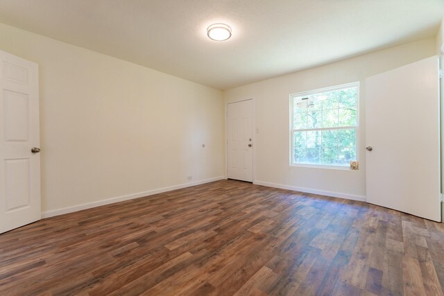 103 N 6th St E, Dawson, TX 76639 - unfurnished room featuring dark wood-style floors and baseboards