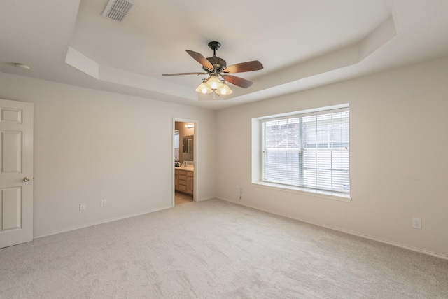 8301 Clearbrook Dr, Fort Worth, TX 76123 - unfurnished bedroom with a raised ceiling, light carpet, baseboards, ensuite bath, and ceiling fan