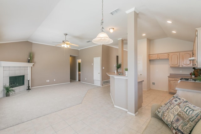 8301 Clearbrook Dr, Fort Worth, TX 76123 - kitchen with light brown cabinets, vaulted ceiling, open floor plan, a ceiling fan, and light tile patterned floors