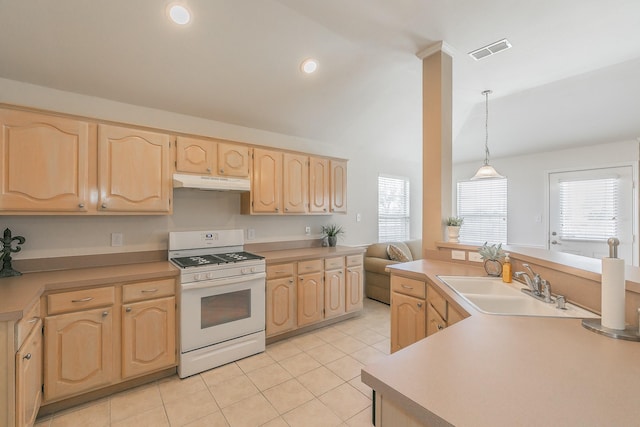 8301 Clearbrook Dr, Fort Worth, TX 76123 - kitchen with white range with gas stovetop, light brown cabinetry, under cabinet range hood, a sink, and light tile patterned flooring