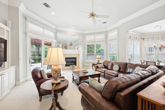3024 Greenhill Dr, Plano, TX 75093 - living area featuring a tiled fireplace, plenty of natural light, a ceiling fan, ornamental molding, and a chandelier