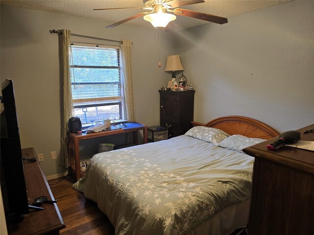 231 County Road 34715, Paris, TX 75460 - bedroom with dark wood finished floors, a textured ceiling, a ceiling fan, and baseboards