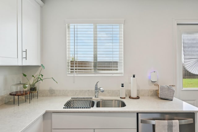 1229 Autumn Mist Ln, Forney, TX 75126 - kitchen featuring a sink, stainless steel dishwasher, white cabinets, and light countertops