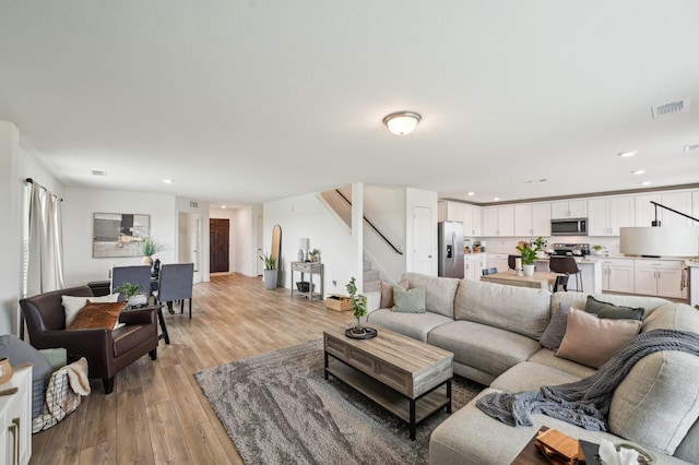 1229 Autumn Mist Ln, Forney, TX 75126 - living room with light wood finished floors, stairs, and recessed lighting