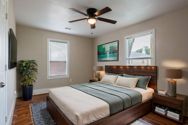 409 Forby Ave, Fort Worth, TX 76103 - bedroom with multiple windows, wood finished floors, baseboards, and a ceiling fan