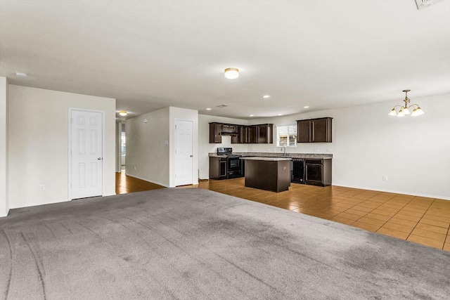 133 Feverbush Dr, Fate, TX 75189 - unfurnished living room with carpet, a chandelier, tile patterned flooring, baseboards, and recessed lighting
