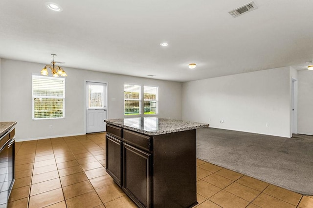 133 Feverbush Dr, Fate, TX 75189 - kitchen featuring light tile patterned flooring, a chandelier, light carpet, recessed lighting, and dark brown cabinets