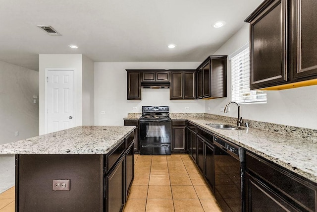 133 Feverbush Dr, Fate, TX 75189 - kitchen with black appliances, a sink, light tile patterned floors, under cabinet range hood, and light stone countertops