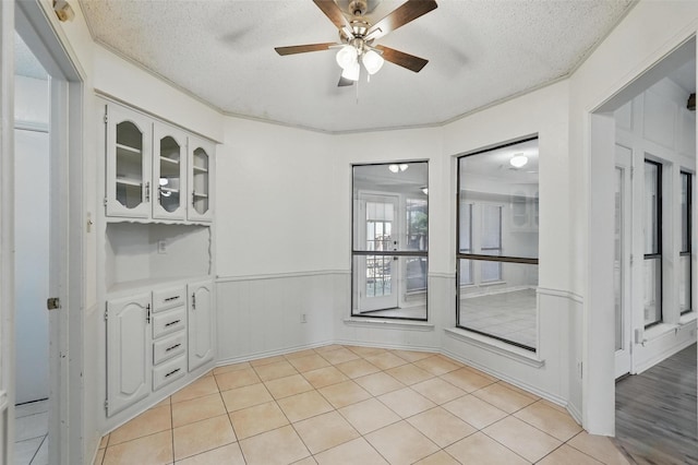 1027 Ridgeview Cir, Carrollton, TX 75007 - unfurnished dining area featuring a textured ceiling, a ceiling fan, and light tile patterned floors