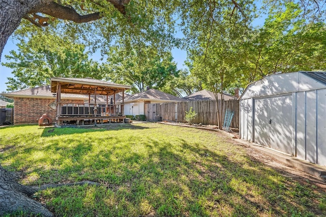 1027 Ridgeview Cir, Carrollton, TX 75007 - view of yard with a storage shed, an outbuilding, and a wooden deck