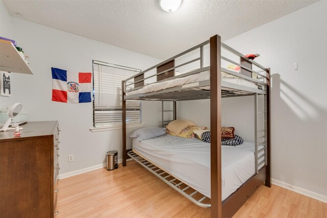 4732 Darla Dr, Fort Worth, TX 76132 - bedroom featuring wood finished floors, baseboards, and a textured ceiling