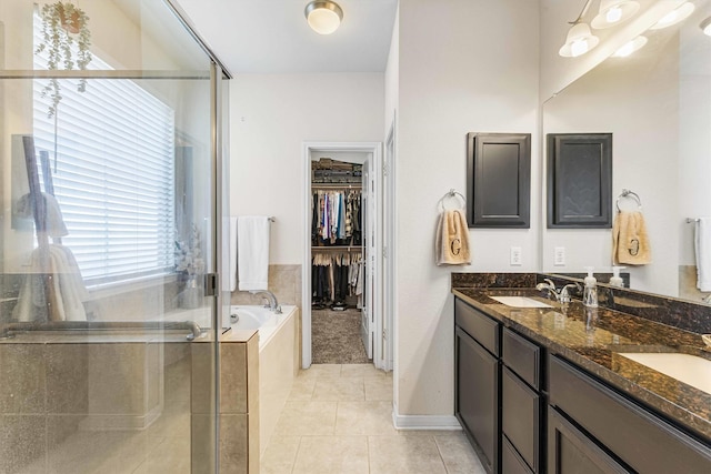 10805 Aurora Dr, Waco, TX 76708 - full bath featuring a shower stall, tile patterned flooring, double vanity, a bath, and a walk in closet