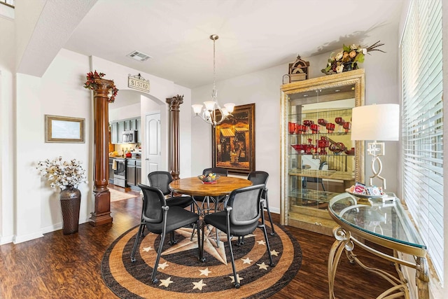 10805 Aurora Dr, Waco, TX 76708 - dining space featuring ornate columns, dark wood finished floors, arched walkways, and baseboards