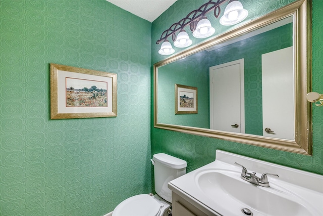 2043 Fleur De Lis Ct, Arlington, TX 76012 - bathroom with toilet, vanity, and wallpapered walls