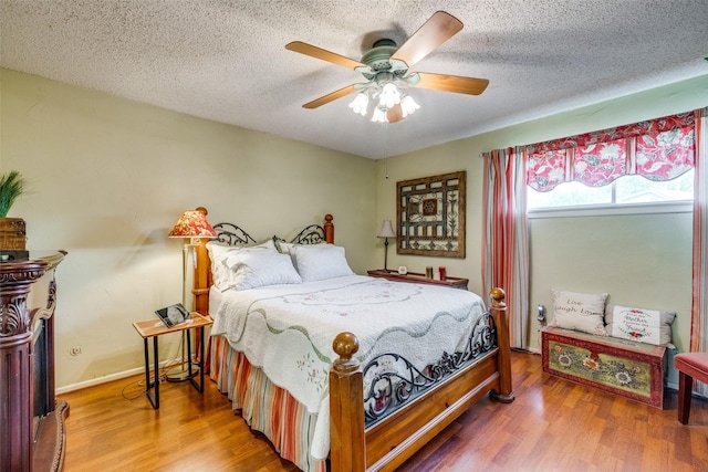 2043 Fleur De Lis Ct, Arlington, TX 76012 - bedroom with wood finished floors, a textured ceiling, and ceiling fan