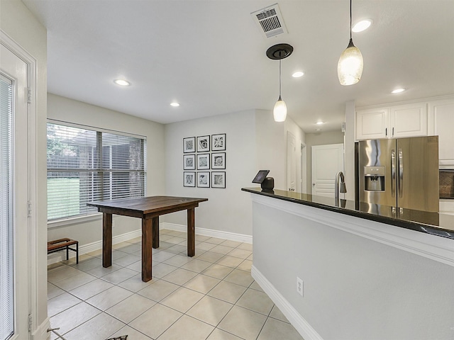 832 Adams Dr, Burleson, TX 76028 - kitchen featuring stainless steel fridge with ice dispenser, dark countertops, hanging light fixtures, recessed lighting, and white cabinets