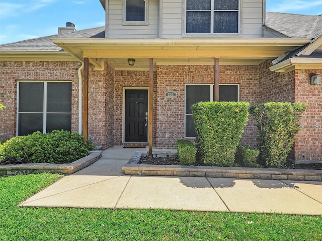 832 Adams Dr, Burleson, TX 76028 - entrance to property with brick siding, a shingled roof, and a porch