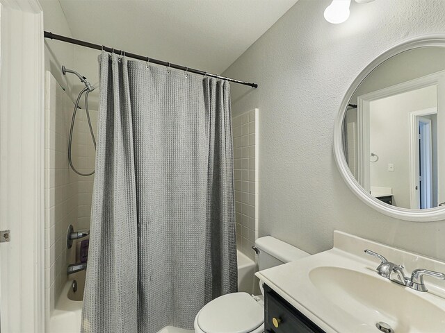 832 Adams Dr, Burleson, TX 76028 - bathroom with shower / bath combo with shower curtain, toilet, a textured wall, and vanity