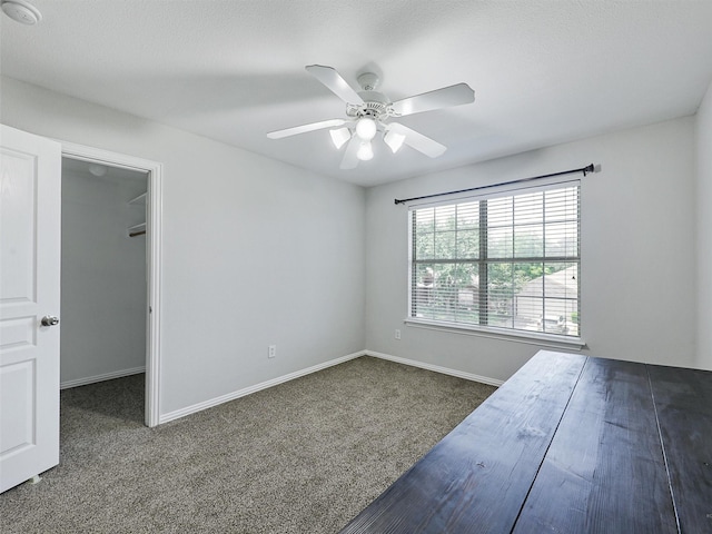 832 Adams Dr, Burleson, TX 76028 - unfurnished bedroom featuring carpet, baseboards, a walk in closet, and a ceiling fan