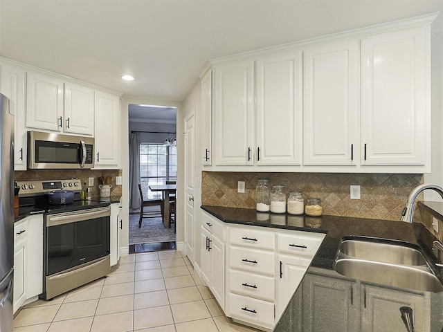 832 Adams Dr, Burleson, TX 76028 - kitchen with stainless steel appliances, a sink, light tile patterned floors, white cabinets, and recessed lighting