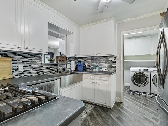 5433 Greenwood Way N, Richland Hills, TX 76180 - kitchen with separate washer and dryer, stovetop, dark countertops, freestanding refrigerator, and white cabinetry