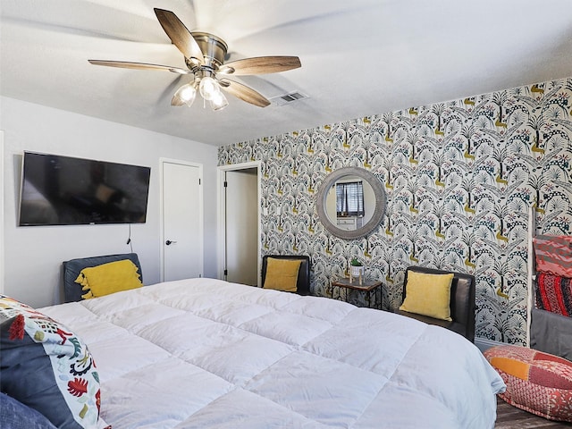 5433 Greenwood Way N, Richland Hills, TX 76180 - bedroom featuring wallpapered walls, ceiling fan, and an accent wall