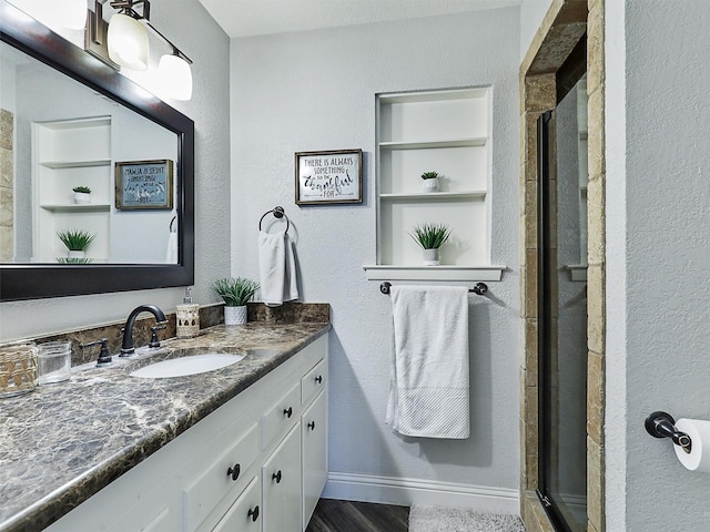 5433 Greenwood Way N, Richland Hills, TX 76180 - full bath featuring a stall shower, vanity, a textured wall, wood finished floors, and built in features
