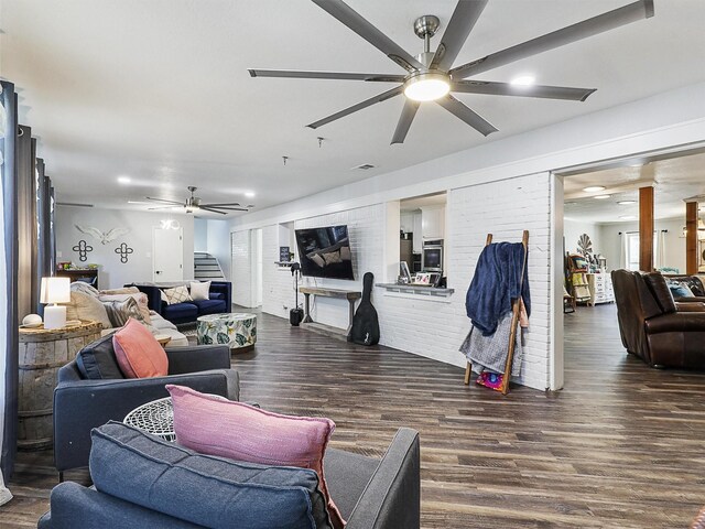 5433 Greenwood Way N, Richland Hills, TX 76180 - living room with a ceiling fan, dark wood finished floors, and brick wall